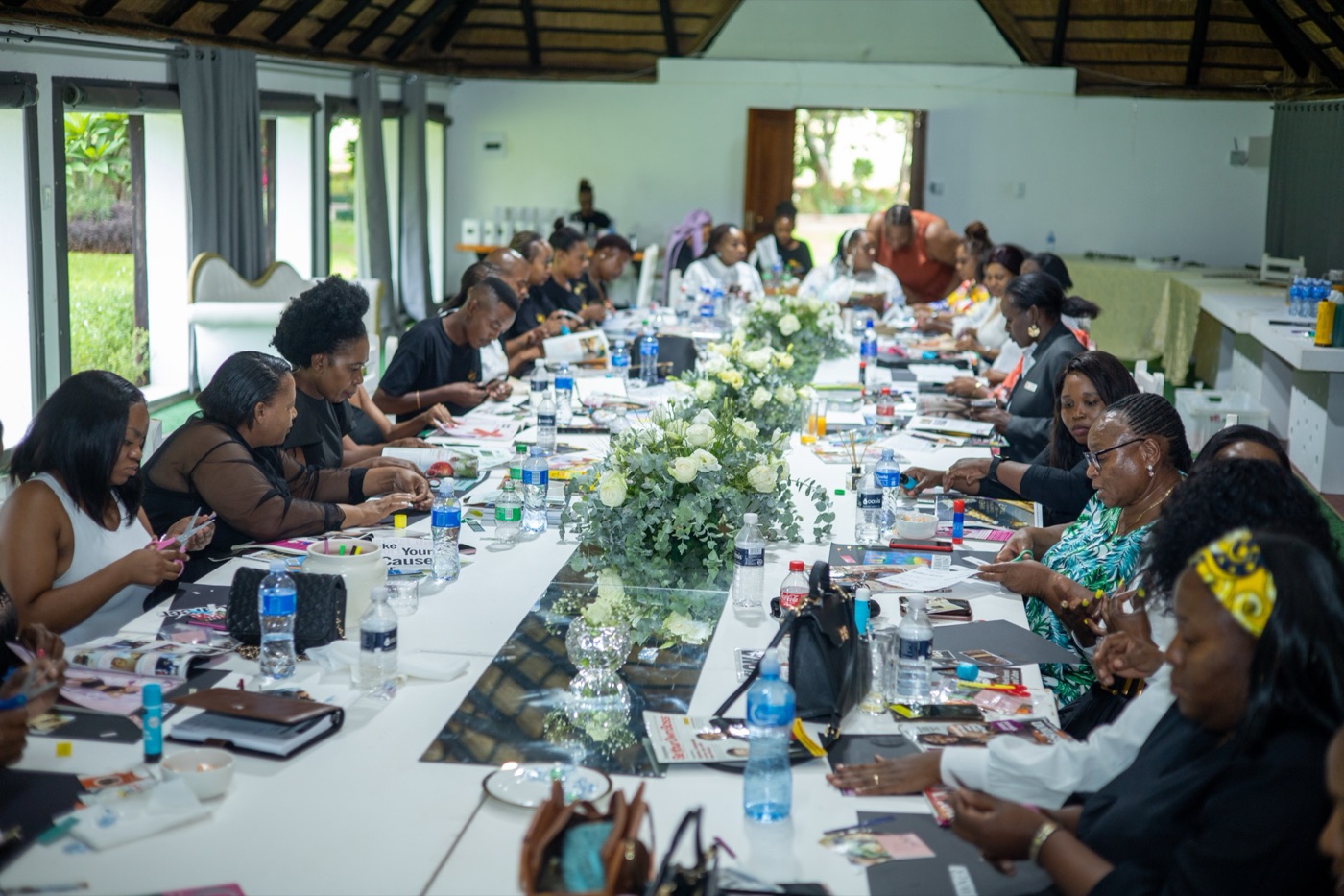 Women gathered around a table during the FEOC and Abigail Arise collaboration